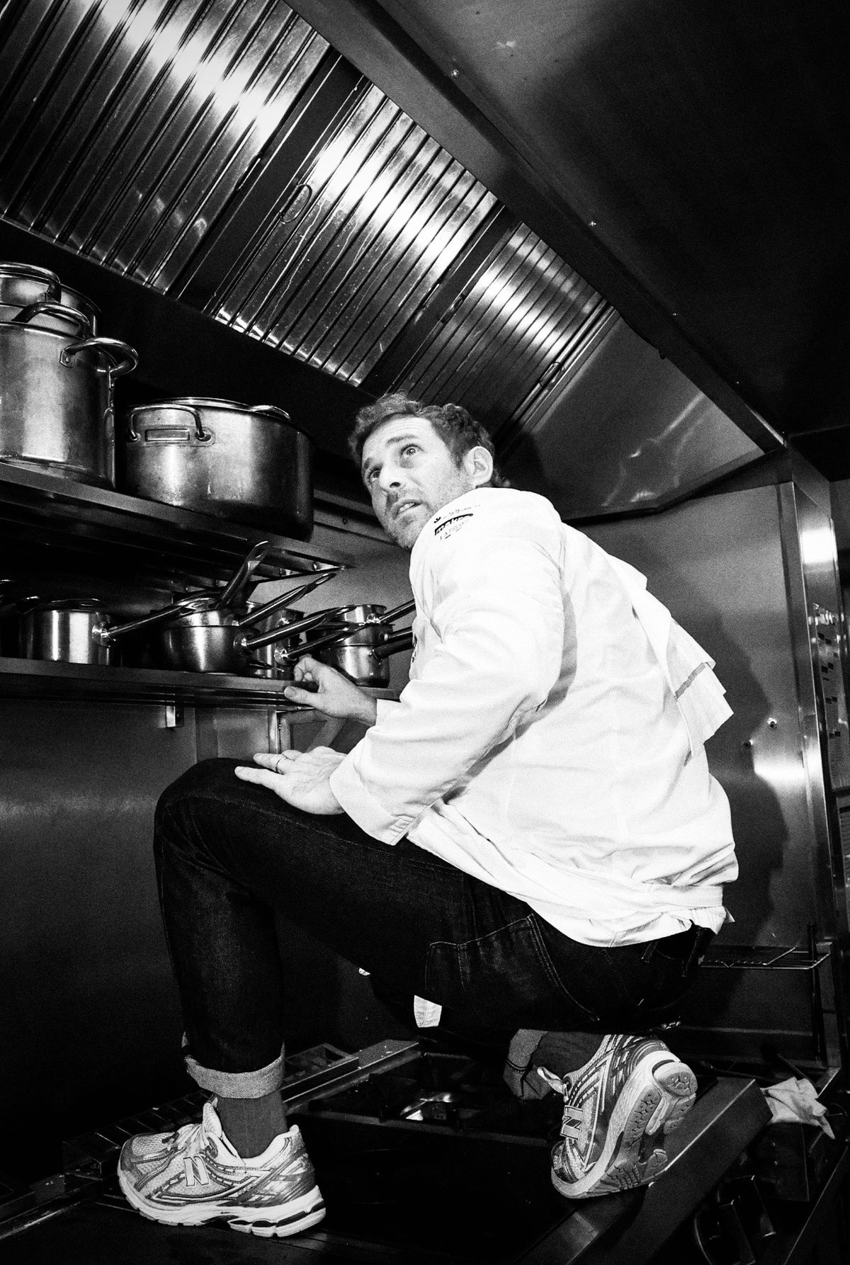 Reaching for a pan under the extraction hood